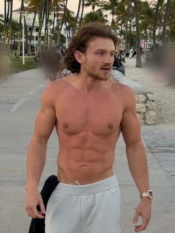 Berke after six months, walking on a beach promenade.